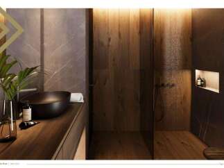 This luxurious bathroom boasts a sleek, dark-toned sink and vanity, complemented by rich wood paneling and marble accents.
