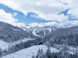 Discover the breathtaking beauty of this snow-covered mountain landscape, perfect for a serene winter getaway.