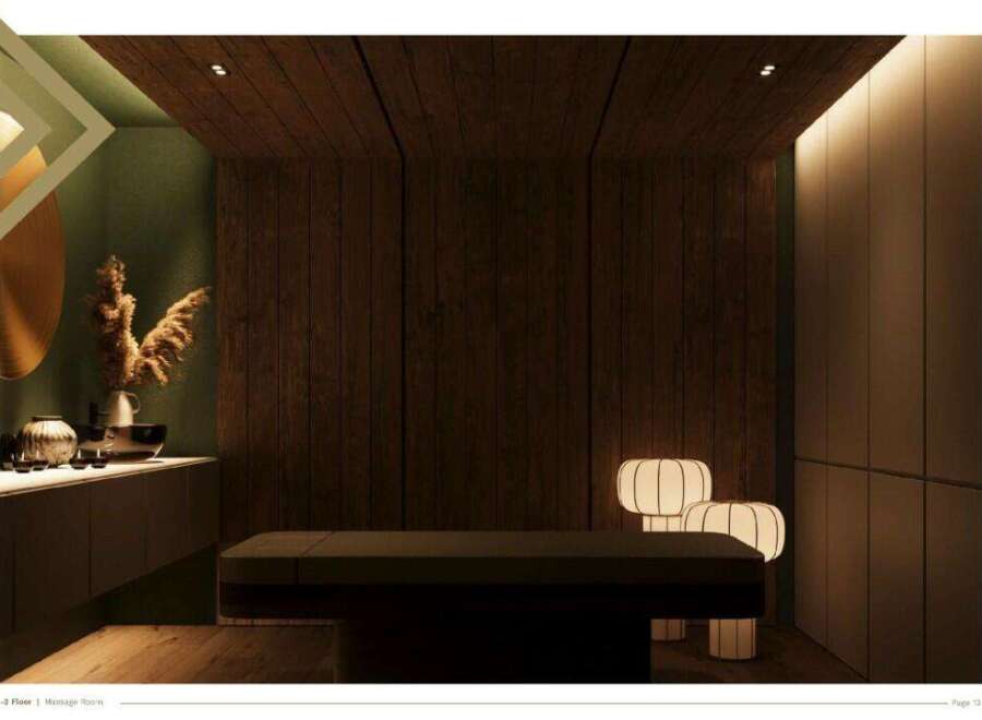 This serene massage room boasts a minimalist design with dark wood paneling, soft lighting, and calming decor.