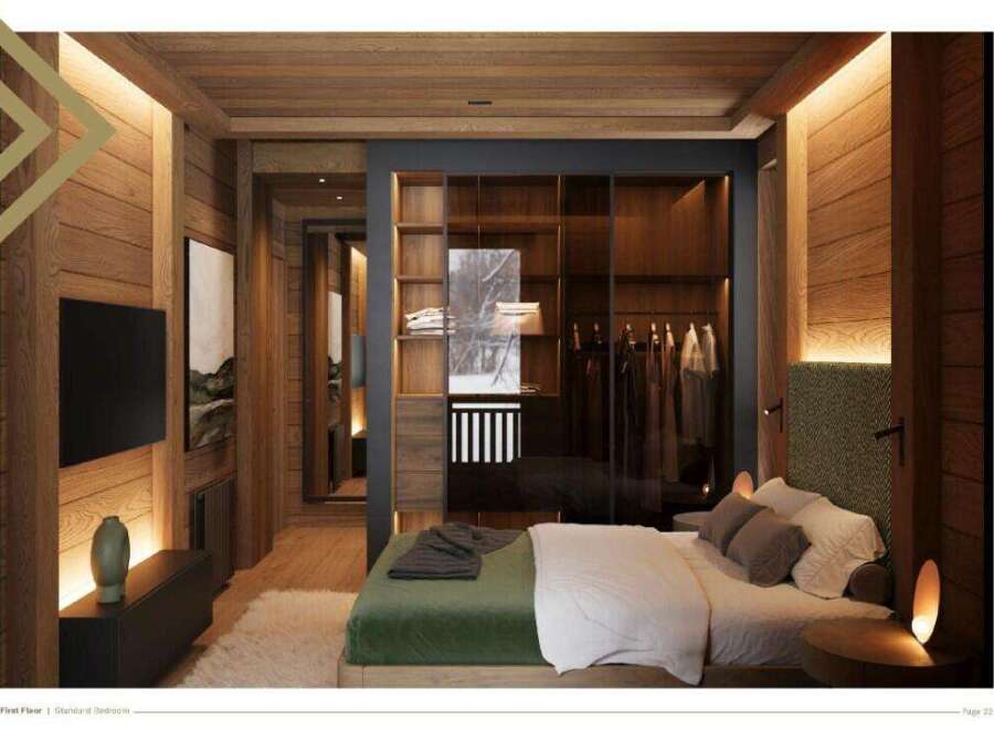 This stunning bedroom boasts a walk-in closet with glass doors, showcasing ample storage space.