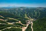 Nestled in a lush mountain range, this stunning property boasts breathtaking views and ski slopes.