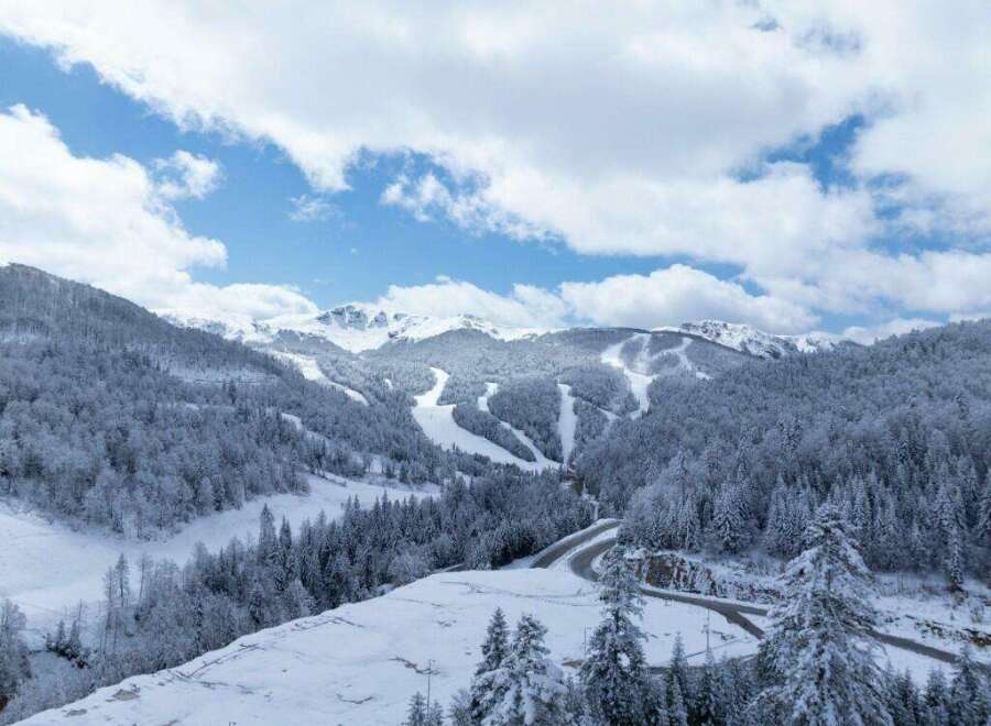 Discover the breathtaking beauty of this snow-covered mountain landscape, perfect for a serene winter getaway.