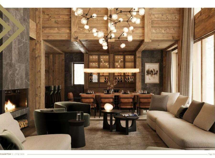This luxurious living room boasts a stunning wooden ceiling, a cozy fireplace, and ample seating for guests.