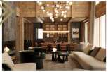 This luxurious living room boasts a stunning wooden ceiling, a cozy fireplace, and ample seating for guests.