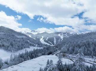 Discover the breathtaking beauty of this snow-covered mountain landscape, perfect for a serene winter getaway.