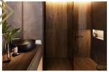 This luxurious bathroom boasts a sleek, dark-toned sink and vanity, complemented by rich wood paneling and marble accents.