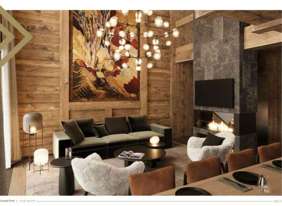 This luxurious chalet boasts a spacious living room with a stunning stone fireplace, plush seating, and large artwork.