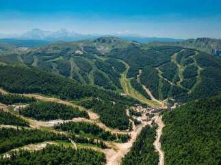 Nestled in a lush mountain range, this stunning property boasts breathtaking views and ski slopes.