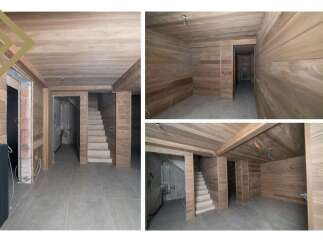 This stunning property boasts a beautifully finished basement with wood paneling on the walls and ceilings, creating a warm and inviting atmosphere.