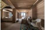 This stunning chalet boasts a spacious open-plan living area with floor-to-ceiling windows offering breathtaking mountain views.