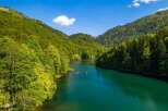 Nestled in a lush green valley, this serene lake offers breathtaking views of the surrounding mountains.