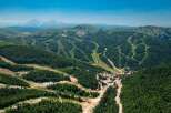 Nestled in a lush mountain range, this stunning property boasts breathtaking views and ski slopes.