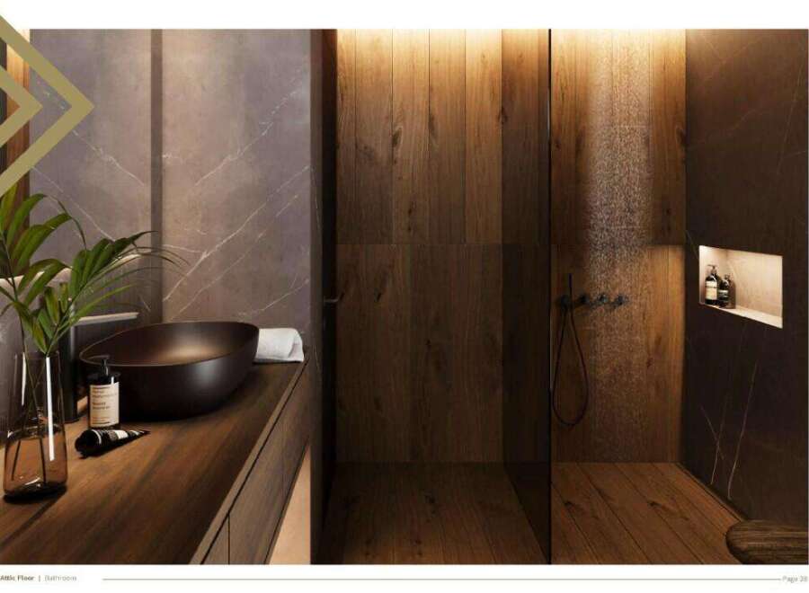 This luxurious bathroom boasts a sleek, dark-toned sink and vanity, complemented by rich wood paneling and marble accents.