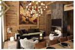 This luxurious chalet boasts a spacious living room with a stunning stone fireplace, plush seating, and large artwork.