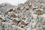 Discover luxurious chalets nestled in a snow-covered mountainside, offering breathtaking views and a serene escape.