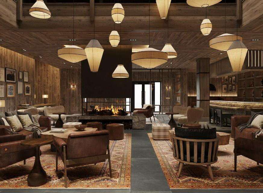 This stunning hotel lobby boasts a rustic-chic design with a cozy fireplace as its centerpiece.