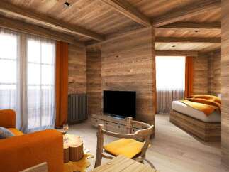 This stunning wooden chalet boasts a cozy living area with an orange couch and a rustic wooden coffee table, perfect for relaxing after a day of adventure.