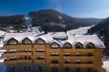 This stunning wooden chalet boasts breathtaking mountain views and offers luxurious accommodations perfect for a ski getaway.
