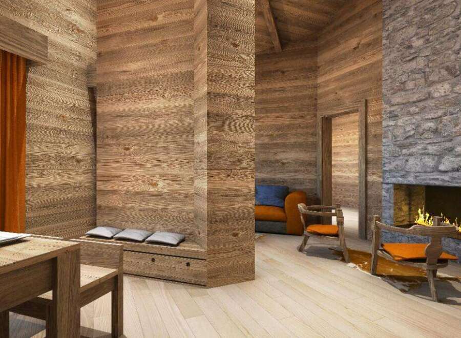 This stunning chalet boasts a cozy living area with a wood-burning fireplace, creating a warm and inviting atmosphere.