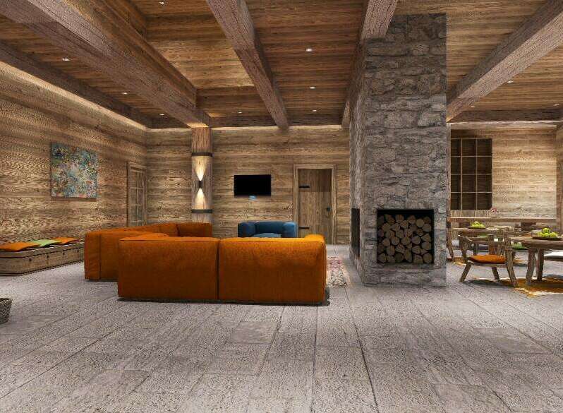 This stunning chalet boasts a spacious open-plan living area with a cozy fireplace, perfect for relaxing after a day on the slopes.