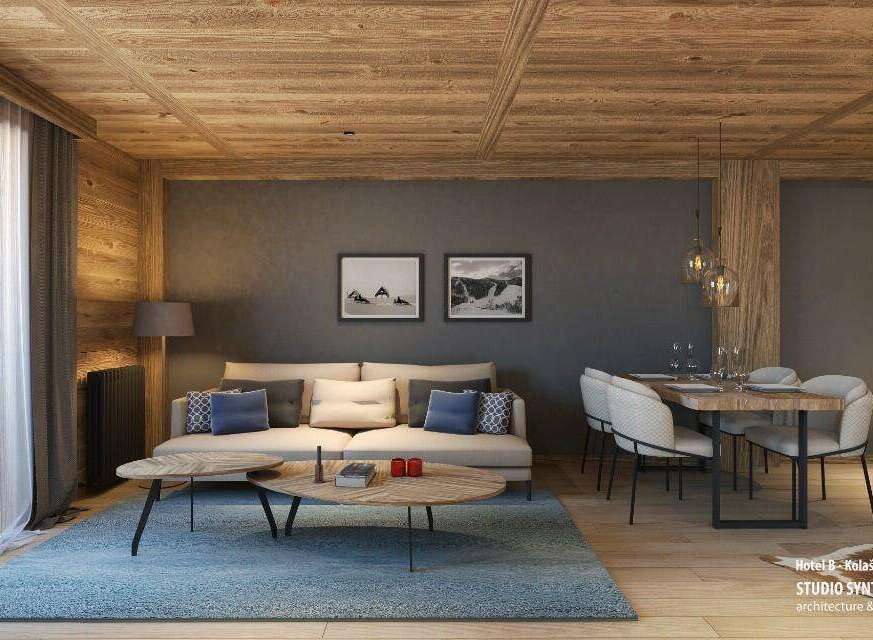 This stunning hotel room boasts a spacious living area with a comfortable sofa and modern coffee tables, perfect for relaxation.