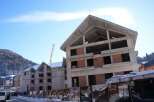 This unfinished hotel is situated in a mountainous region, offering stunning views.