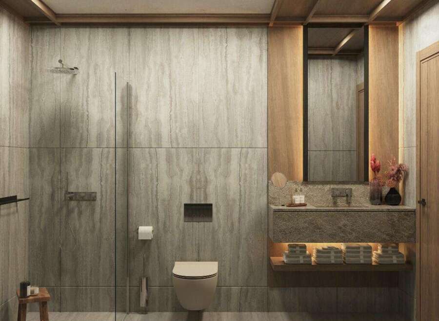 This luxurious bathroom boasts a serene atmosphere with its natural stone wall tiles and wooden accents.