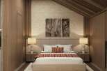 This stunning bedroom boasts a cozy and sophisticated atmosphere, featuring a plush bed with a textured headboard and warm-toned bedding.