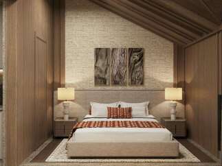 This stunning bedroom boasts a cozy and sophisticated atmosphere, featuring a plush bed with a textured headboard and warm-toned bedding.