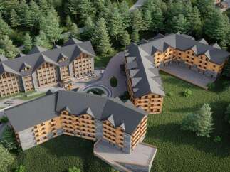 Nestled in a lush forest, this stunning hotel complex boasts multiple buildings with charming wooden accents and spacious balconies.
