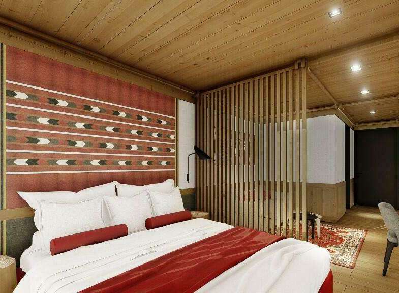 This hotel room features a comfortable king-size bed with plush bedding and a stylish red throw.