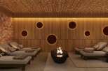 Indulge in ultimate relaxation in this luxurious spa, featuring a stunning Himalayan salt wall, ambient lighting, and comfortable lounge chairs.
