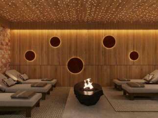Indulge in ultimate relaxation in this luxurious spa, featuring a stunning Himalayan salt wall, ambient lighting, and comfortable lounge chairs.
