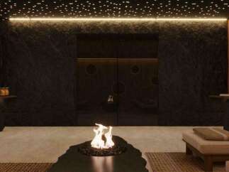 Indulge in tranquility at this luxurious spa, featuring a stunning fire pit as its centerpiece.