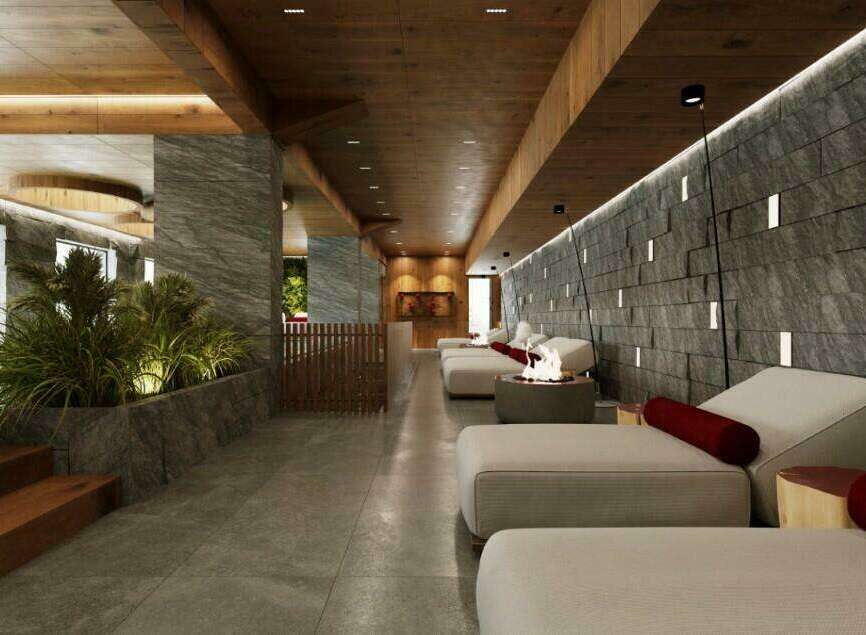 Indulge in ultimate relaxation at our luxurious spa, featuring a stunning indoor pool and comfortable lounge area with individual fire pits.