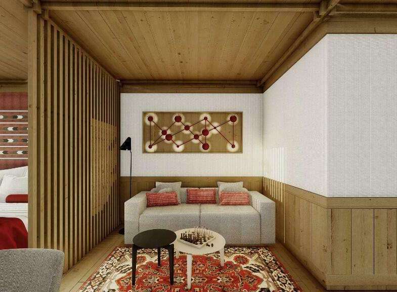 This stunning hotel room boasts a unique blend of modern and traditional design, featuring a cozy sitting area with a comfortable sofa and a stylish rug.