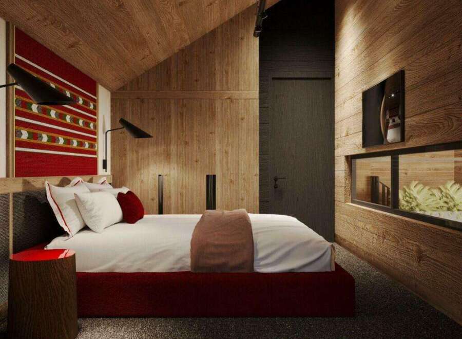 This stunning bedroom boasts a cozy and modern design, featuring a plush bed with a red base, complemented by a textured red and white wall hanging.