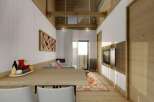 This stunning apartment boasts a spacious open-plan living area with a sleek modern kitchen and dining area.