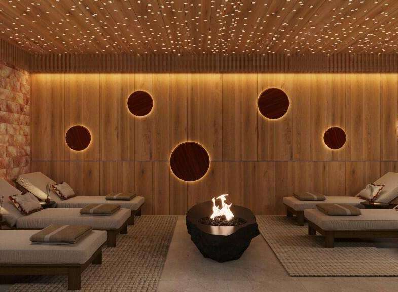 Indulge in ultimate relaxation in this luxurious spa, featuring a stunning Himalayan salt wall, ambient lighting, and comfortable lounge chairs.
