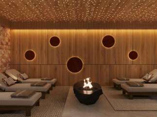 Indulge in ultimate relaxation in this luxurious spa, featuring a stunning Himalayan salt wall, ambient lighting, and comfortable lounge chairs.
