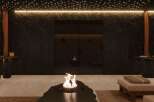 Indulge in tranquility at this luxurious spa, featuring a stunning fire pit as its centerpiece.