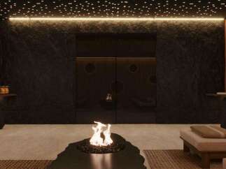 Indulge in tranquility at this luxurious spa, featuring a stunning fire pit as its centerpiece.