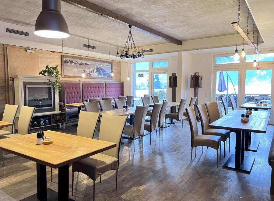 Experience the charm of this inviting restaurant, featuring a cozy fireplace and elegant dining areas.