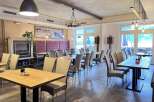 Experience the charm of this inviting restaurant, featuring a cozy fireplace and elegant dining areas.