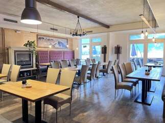 Experience the charm of this inviting restaurant, featuring a cozy fireplace and elegant dining areas.