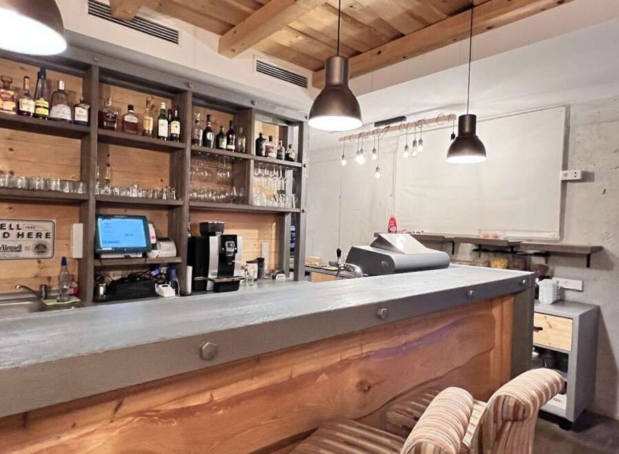 This stylish bar boasts a rustic wooden interior with a modern touch.