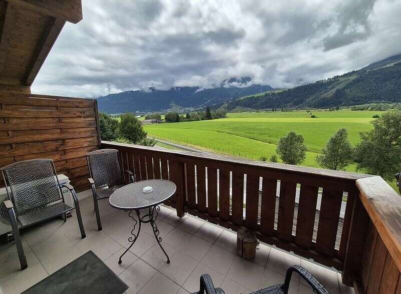 Enjoy breathtaking mountain views from this charming balcony.