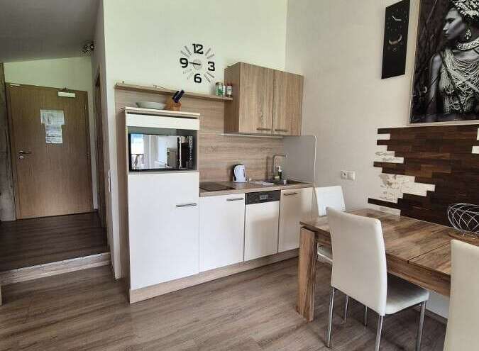 Discover a stylish kitchen with modern appliances and ample counter space, perfect for preparing delicious meals.