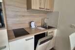 Discover a compact yet functional kitchen space, perfect for efficient living.