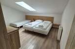 This cozy room features a comfortable bed and a single bed, perfect for a relaxing stay.